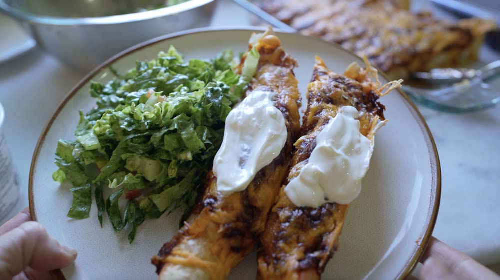 delicious chicken enchiladas with sour cream on top